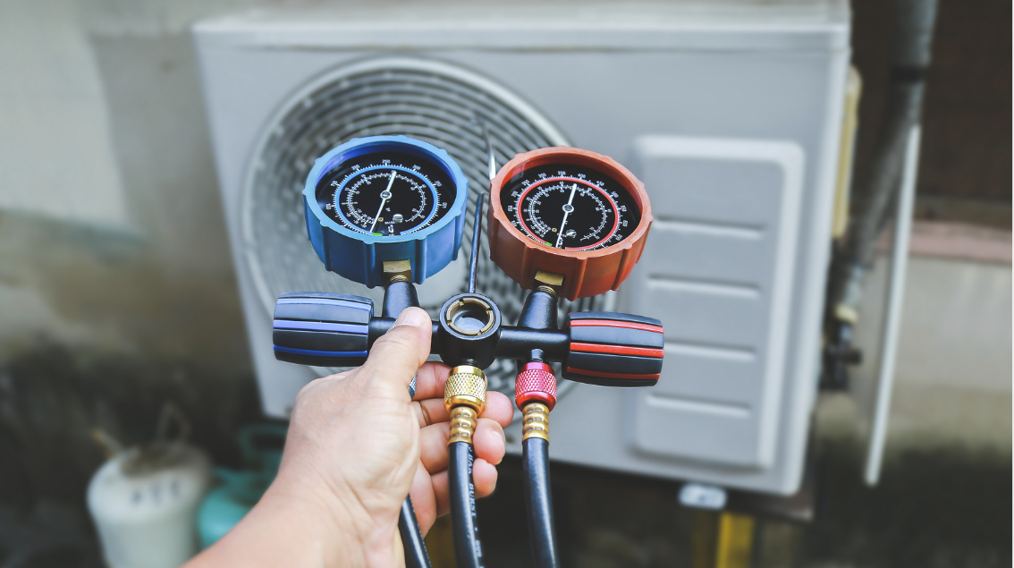 A technician inspecting a residential AC unit.