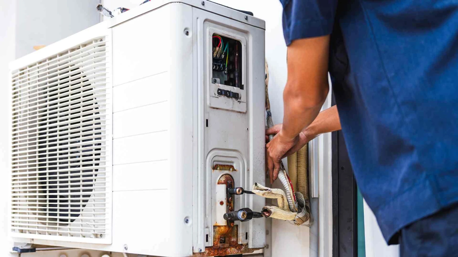 A technician servicing an HVAC unit.