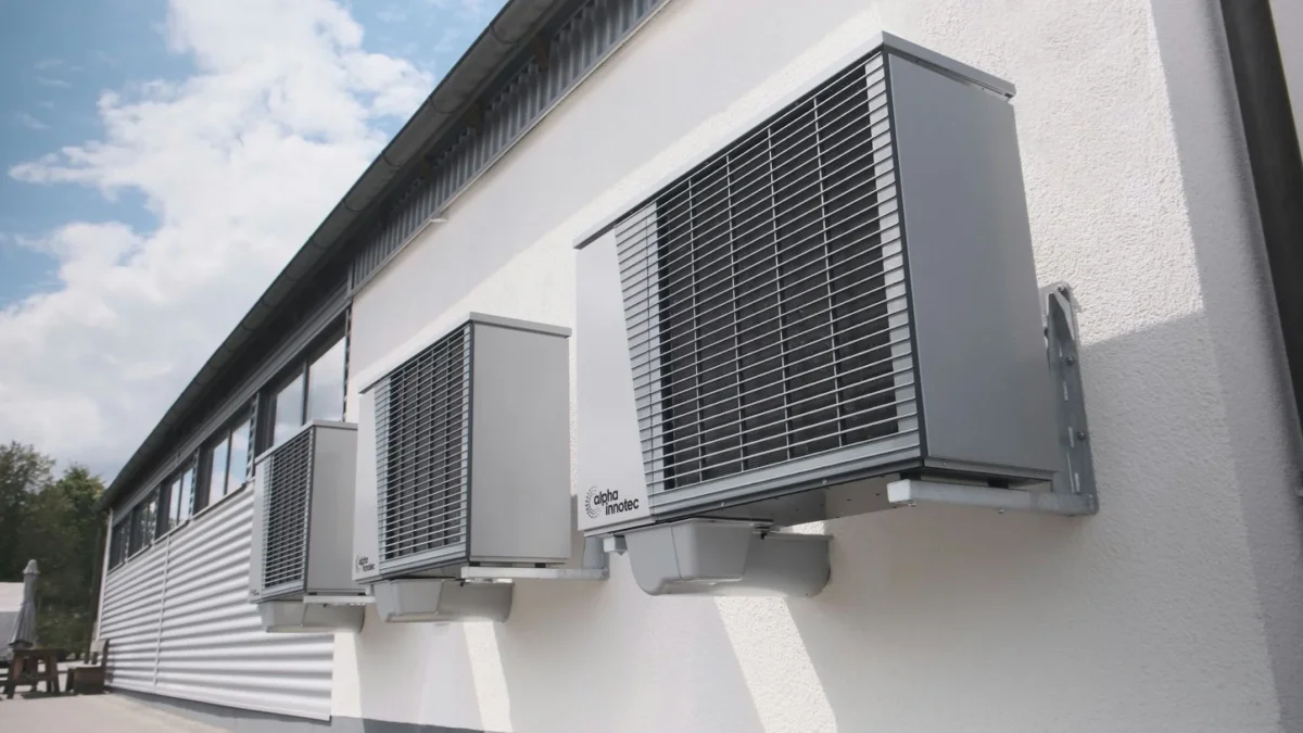 AC units hanging from an building's exterior wall.